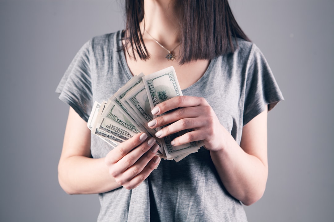 Person planning monthly investment savings for dollar cost averaging strategy